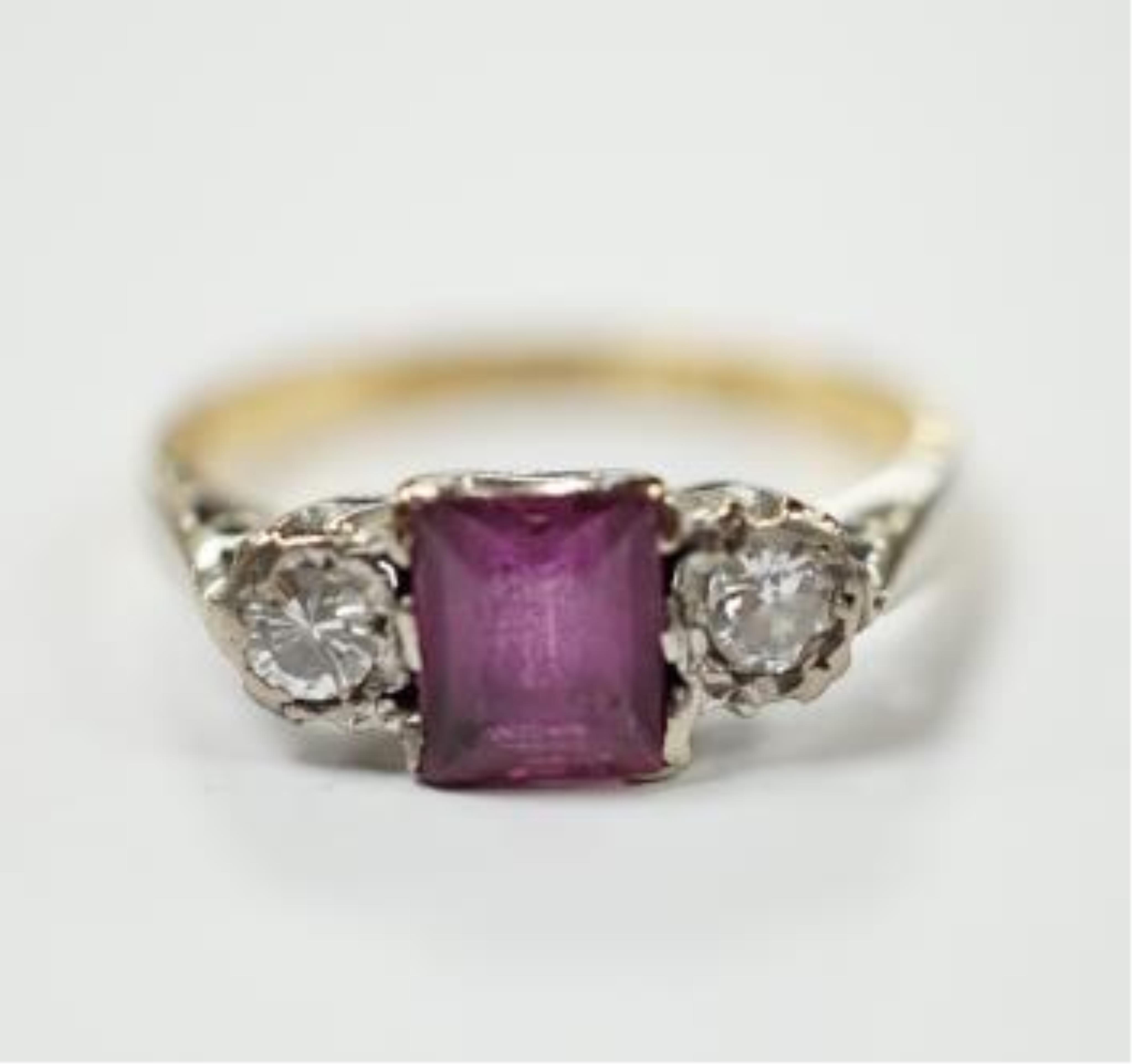 An 18ct & plat. ruby and diamond set three stone ring, size K, gross weight 2.3 grams. Condition - fair